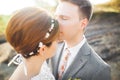 Bride and groom holding beautiful wedding bouquet. Posing near river Royalty Free Stock Photo