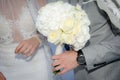 Bride and groom holding bouquet of roses Royalty Free Stock Photo