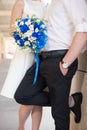 Bride and groom holding bridal bouquet of blue chrysanthemum, freesia, eustoma and peony. close up Royalty Free Stock Photo