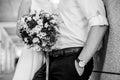 Bride and groom holding bridal bouquet of blue chrysanthemum, freesia, eustoma and peony. close up Royalty Free Stock Photo