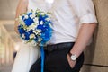 Bride and groom holding bridal bouquet of blue chrysanthemum, freesia, eustoma and peony. close up Royalty Free Stock Photo