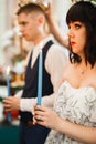 Bride and groom holding candles in church Royalty Free Stock Photo