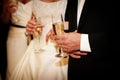 Bride and groom holding champagne flutes
