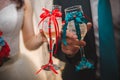 The bride and groom are holding glasses of champagne. Wedding ceremony. Champagne glasses decorated with ribbons close-up Royalty Free Stock Photo