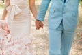 Bride and groom holding hands