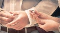 Bride and Groom Holding hands and exchanging rings Royalty Free Stock Photo