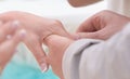 Bride and Groom Holding hands and exchanging rings Royalty Free Stock Photo