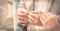 Bride and Groom Holding hands and exchanging rings Royalty Free Stock Photo