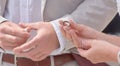 Bride and Groom Holding hands and exchanging rings Royalty Free Stock Photo