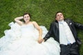Bride and groom holding hands on lawn Royalty Free Stock Photo