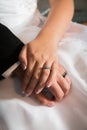 Bride and groom holding hands showing rings Royalty Free Stock Photo