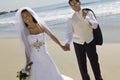 Bride And Groom Holding Hands While Walking On Beach Royalty Free Stock Photo