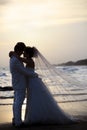 Bride and groom holding and hug at sea side in dus