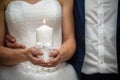 The bride and groom are holding a lighted candle in their hands Royalty Free Stock Photo