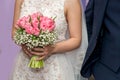 Bride and groom holding their hands - detail.