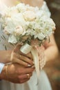 the bride and groom hug each other and hold a wedding bouquet. Royalty Free Stock Photo