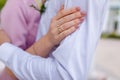 Bride and groom hugging, close up shot of shoulders and hands. Wedding ring on finger. Tender nude manicure for girl Royalty Free Stock Photo