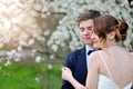 Bride and groom hugging in the flowered Spring Garden wedding walk Royalty Free Stock Photo