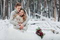 Bride and groom are hugging in the winter forest. Close-up. Winter wedding ceremony. Royalty Free Stock Photo