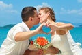 Bride and groom kissing at the beautiful tropical beach, romanti Royalty Free Stock Photo