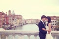 Bride and groom kissing on a bridge Royalty Free Stock Photo