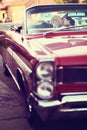 The bride and groom kissing and have fun behind the wheel of red retro vintage car. Wedding. Royalty Free Stock Photo