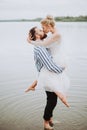 Young just married kissing and hugging on the shoreline Royalty Free Stock Photo