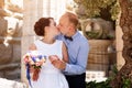 Bride and groom kissing outdoors. Wedding day of happy bridal couple, newlywed woman and man embracing with love in the Royalty Free Stock Photo