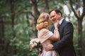 Bride and groom kissing in the summer forest Royalty Free Stock Photo
