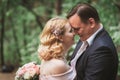 Bride and groom kissing in the summer forest Royalty Free Stock Photo