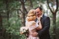 Bride and groom kissing in the summer forest Royalty Free Stock Photo
