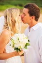Bride and Groom, Kissing at Sunset on a Beautiful Tropical Beach Royalty Free Stock Photo
