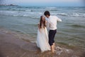 Bride and groom laugh and have a good time on ocean beach. Happy just married couple Royalty Free Stock Photo