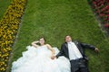 Bride and groom on lawn with flowers Royalty Free Stock Photo