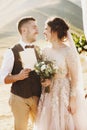 Bride and groom look lovely during the wedding ceremony on the top of the mountain somewhere in Georgia Royalty Free Stock Photo