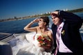 Bride and groom looking forward on the boat Royalty Free Stock Photo
