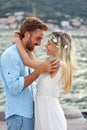 Bride and groom on a love date at seaside, hugging and being joyful. Couple in love. Wedding, travel, love concept