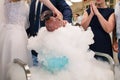 Bride and groom make a cocktail of dry ice, alcohol and juice, glass with the effect of dry ice,blue cocktail with ice vapor, Royalty Free Stock Photo