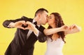 Bride and groom making heart shape with their hands Royalty Free Stock Photo