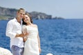 Bride and groom making a toast by the sea in wedding day Royalty Free Stock Photo