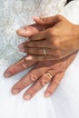 Bride and groom marriage holding hands with wedding rings in white dress background Royalty Free Stock Photo