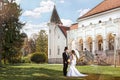 Bride and groom meet in front of the old mansion, romantic, nostalgic scene with sunshine
