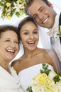 Bride and Groom with mother outdoors (close-up) (portrait) Royalty Free Stock Photo