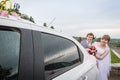 Bride and groom near a car in a wedding Royalty Free Stock Photo