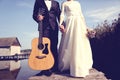 Bride and groom near houses on lake Royalty Free Stock Photo