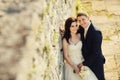 Bride and groom near old ruined castle wall Royalty Free Stock Photo