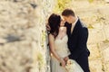 Bride and groom near old ruined castle wall Royalty Free Stock Photo