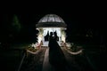 Bride and groom at night near the arch