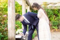 Bride and groom outdoors under wooden pergola signing marriage certificate Royalty Free Stock Photo