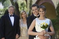 Bride And Groom With Parents In Background